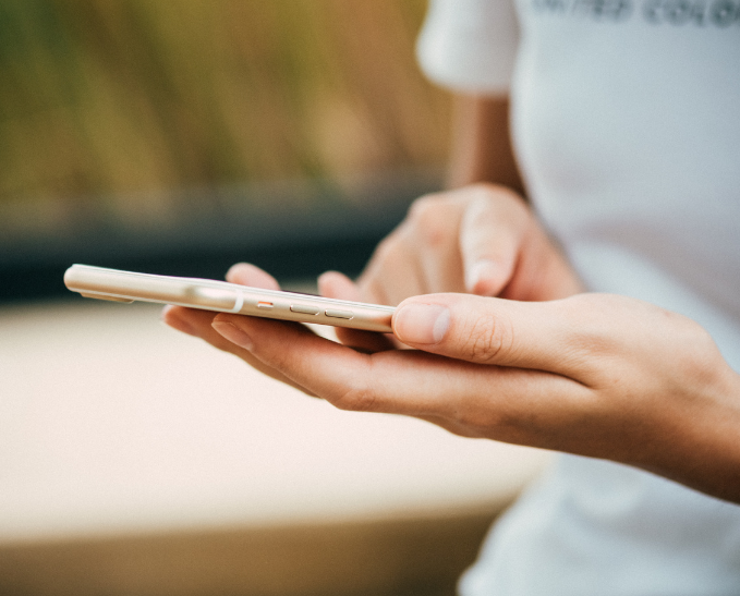 Close up shot of woman's hands holding a cell phone.