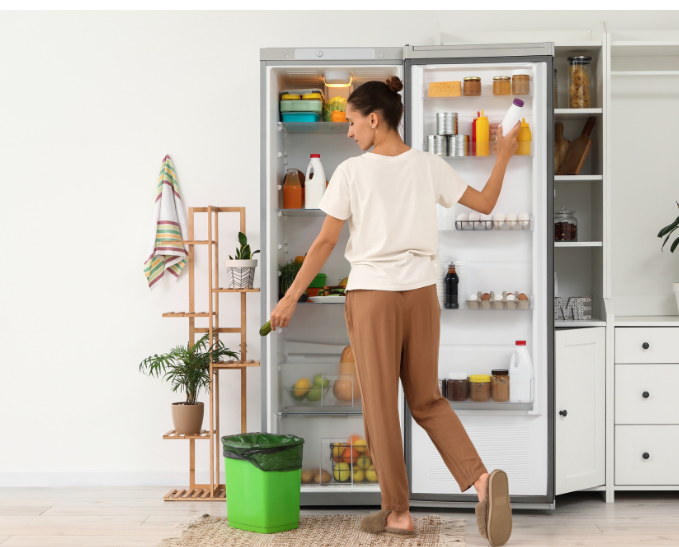 Woman disposing of spoiled food from the fridge.